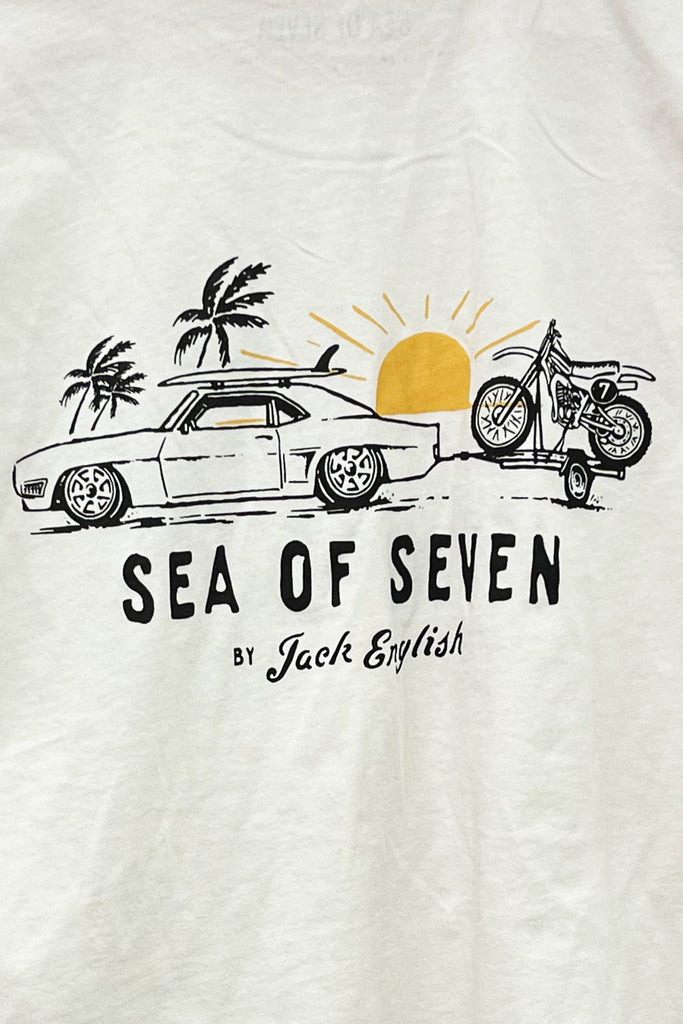 White t-shirt with 'Sea of Seven' graphic design featuring a car, motorcycle, and palm trees.
