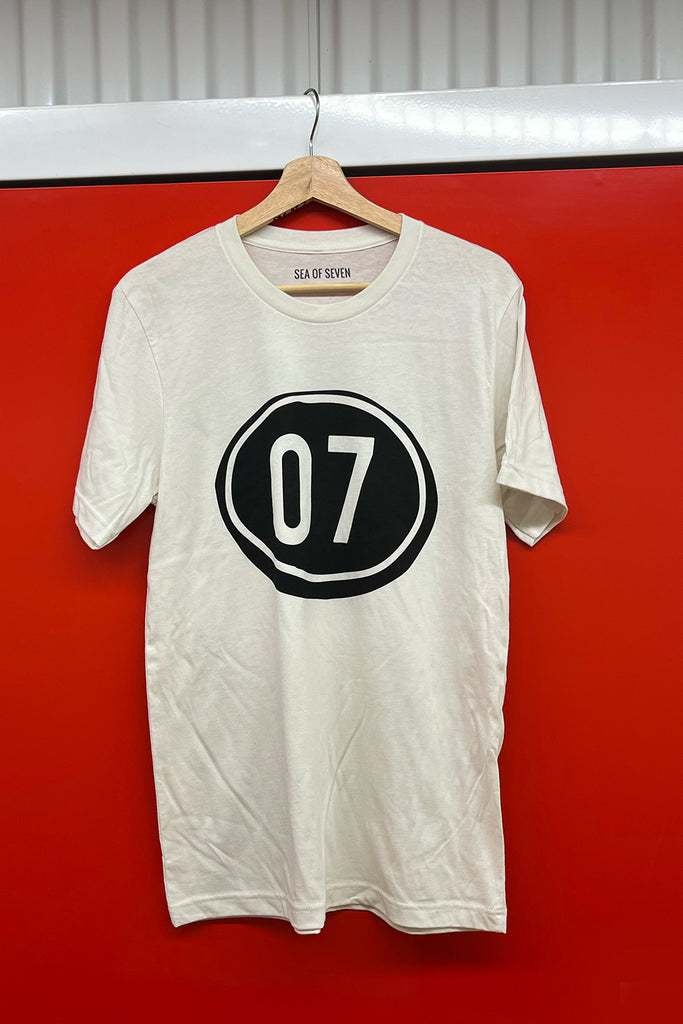 zero seven in a black graphic on the front side of a mens vintage white short sleeve tee - 07 shirt.