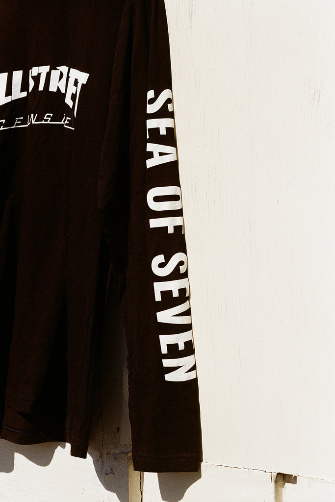 Black t-shirt with 'Ultra' and 'Sea of Seven' text on a white background
