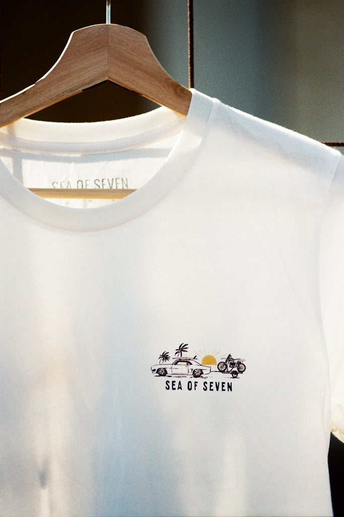 White t-shirt with 'Sea of Seven' logo on a hanger
