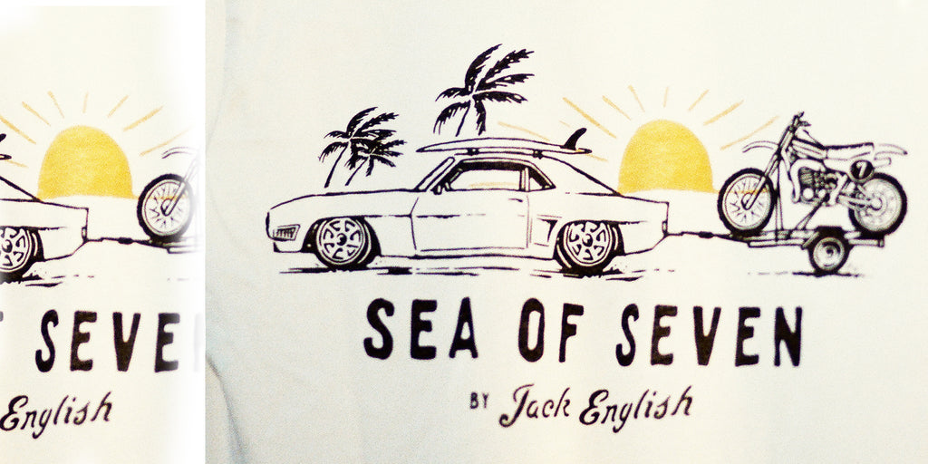 Vintage Camaro car with a surfboard towing a motorcycle