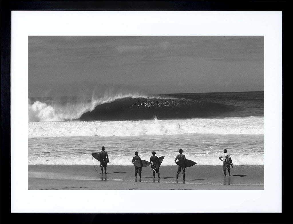 Standing Room Only gallery quality surfing prints of an empty wave at Pipeline on the North Shore of Oahu with a row of surfers standing on the beach holding their surfboards.