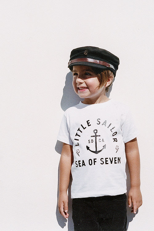 White toddler boys tee Little Sailor with ship anchor and lighting bolts.