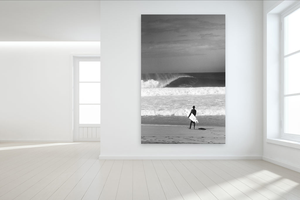 Surfing Wall Mural of a surfer standing on the sand at Pipeline on the North Shore of Oahu in Hawaii and custom surf wallpaper available.